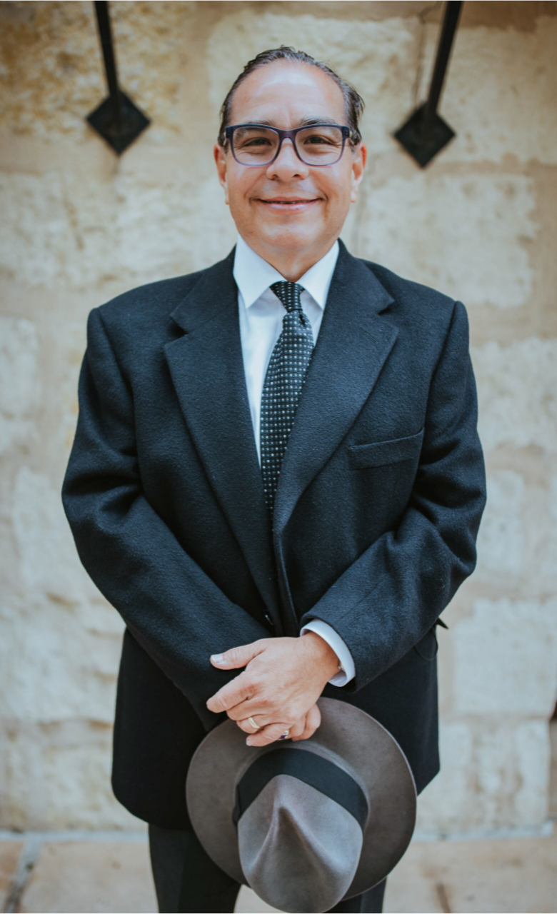 Judge Paul Talamentez with texas wedding ministers smiling and holding his hat