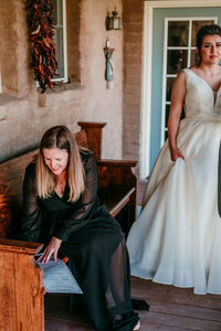 Officiant Amanda Collinsworth, an Officiant with Texas Wedding Ministers signing a marriage license for a couple. Officiant Amanda Collinsworth, with Texas Wedding Ministers, signing a marriage license for a couple at their wedding venue.