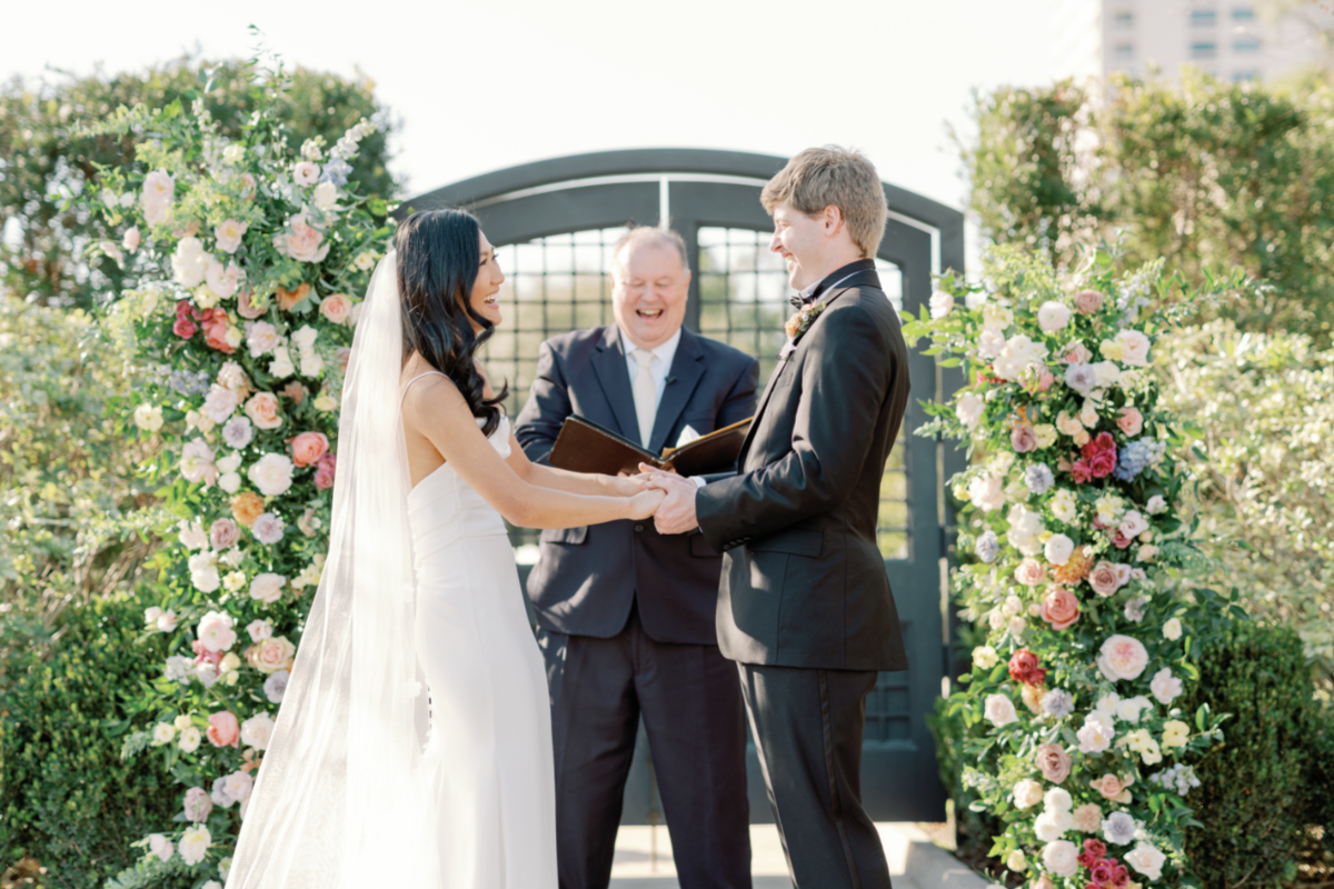Reverend Howard Wayland with Texas Wedding Ministers with couple during wedding ceremony Reverend Howard Wayland with Texas Wedding Ministers laughing with couple during wedding ceremony