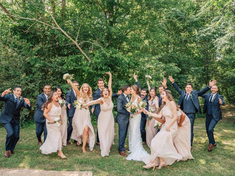 Texas Wedding Ministers Couple kissing while bridal party cheer around them