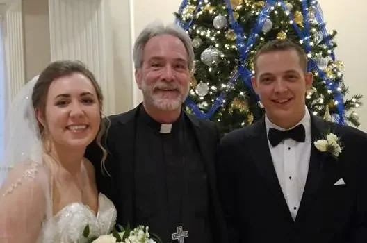Reverend Rand Certain officiates wedding ceremony